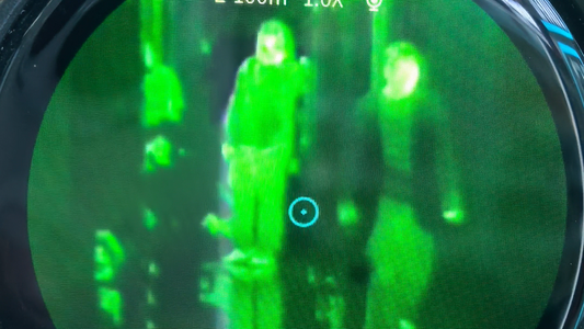 The device shown in the video is a handheld thermal imaging monocular.